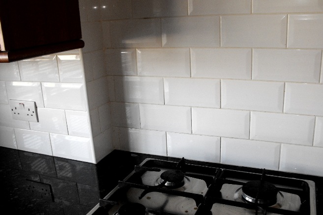 Law Carpentry and Bathrooms created this splashback in a kitchen with tiling in brick formation